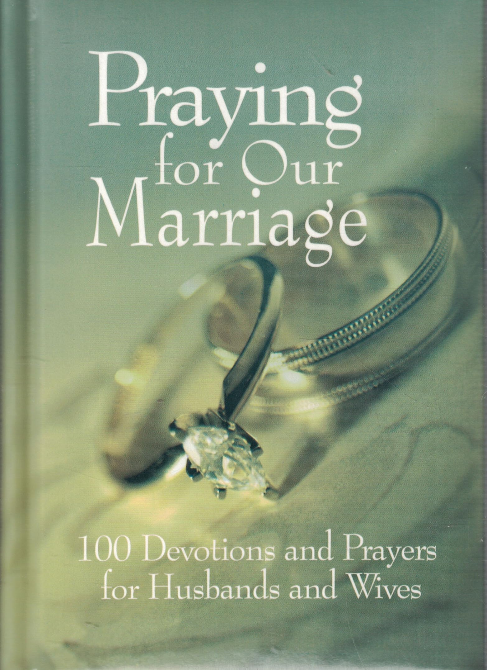 Cover of the book Praying for Our Marriage featuring wedding rings and the title prominently displayed.
