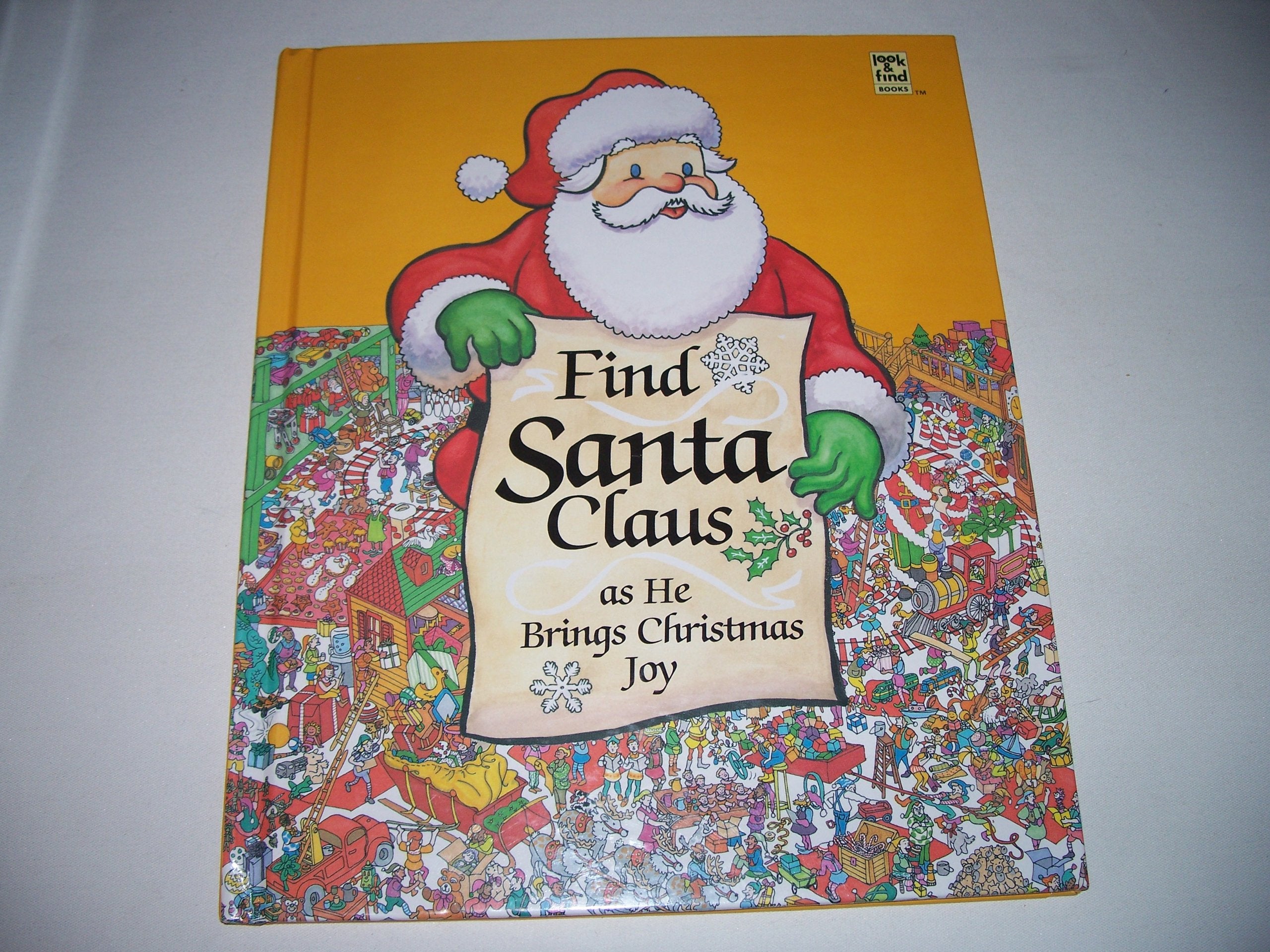 Find Santa Claus as he brings Christmas joy (Look & find books)