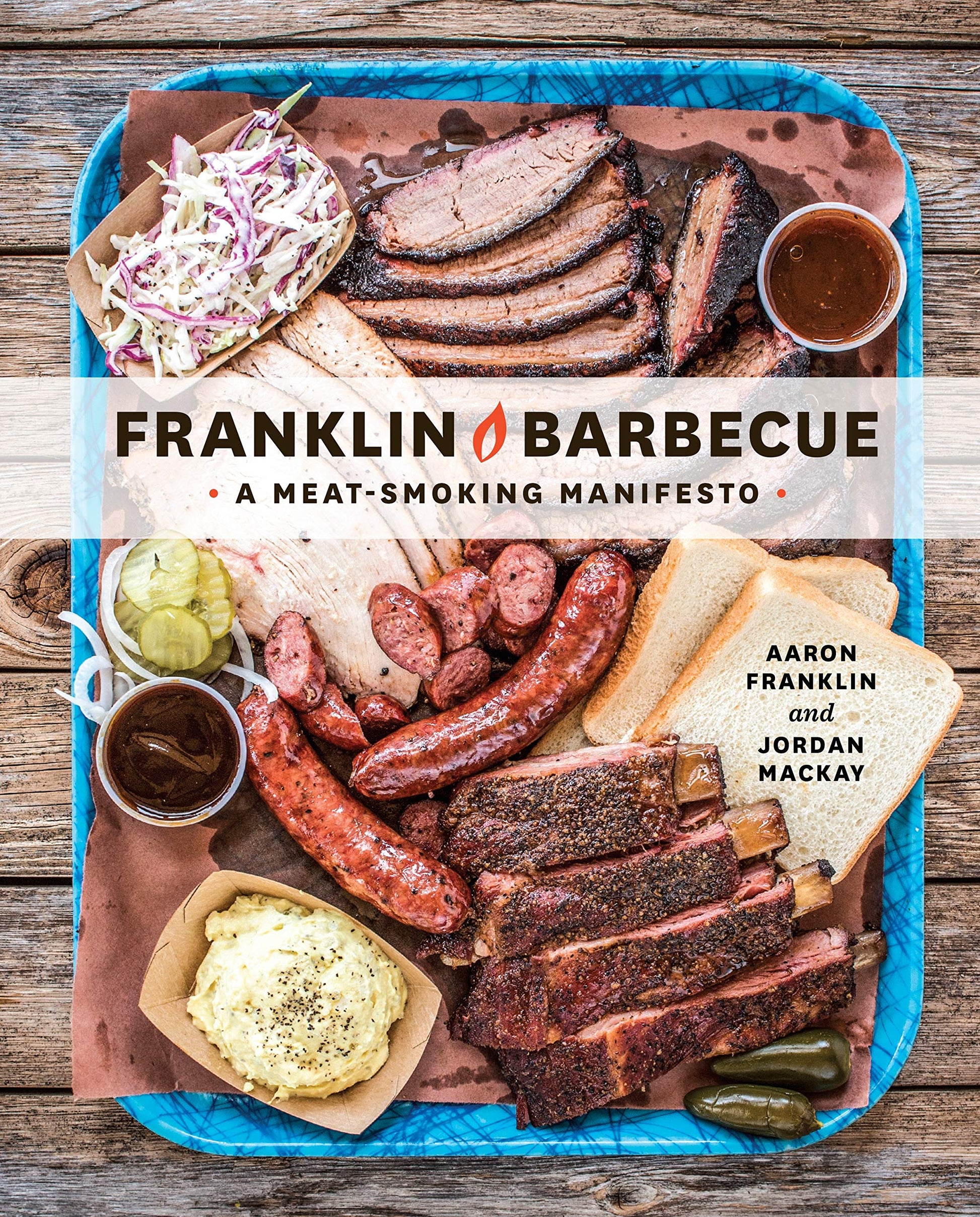 Franklin Barbecue: A Meat-Smoking Manifesto [A Cookbook] featuring smoked meats on a blue tray.